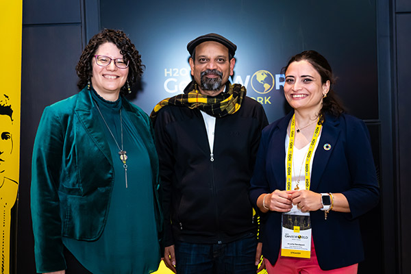 A group of three people posing for the camera.